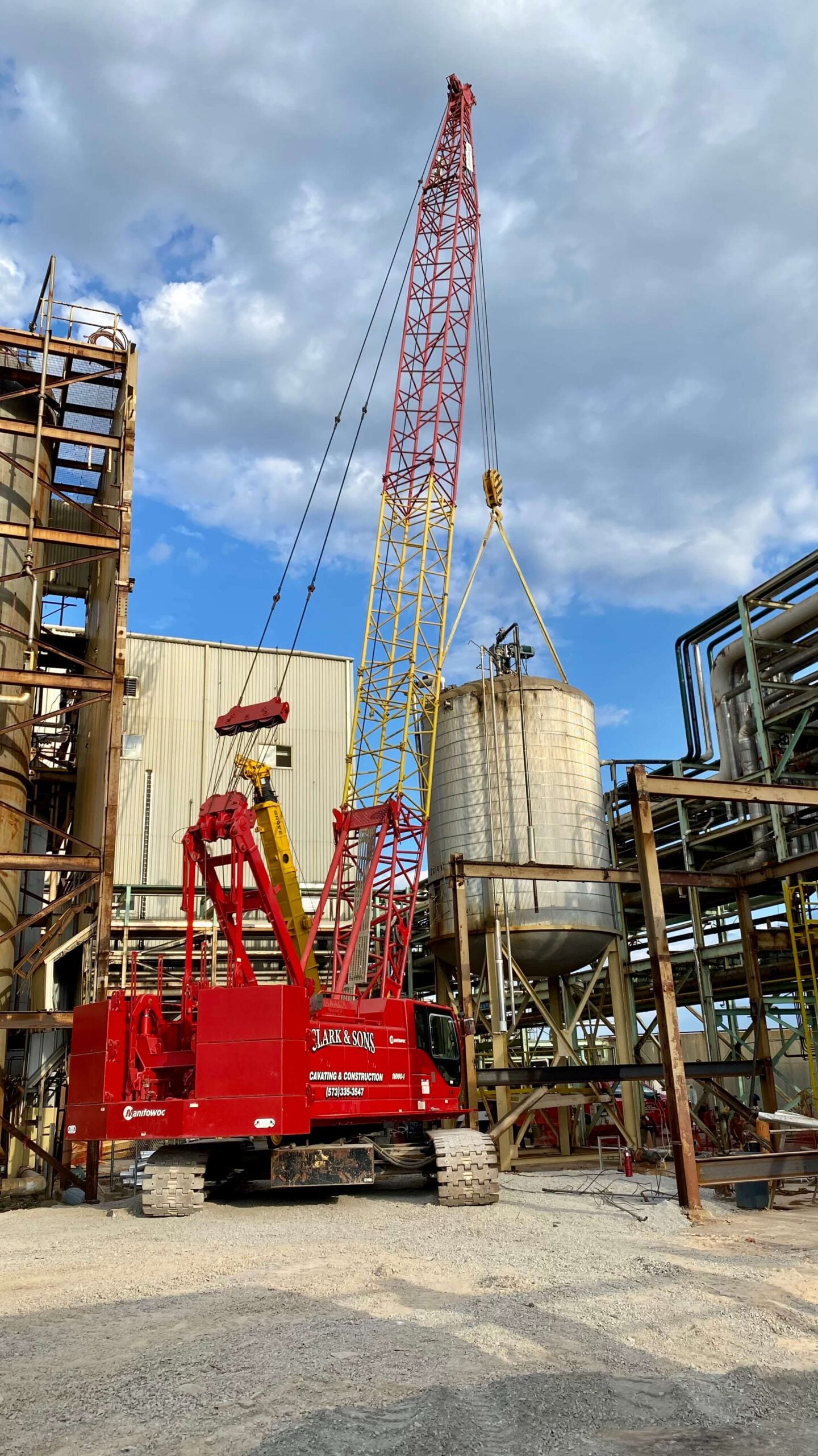 A crane is sitting in front of a building.