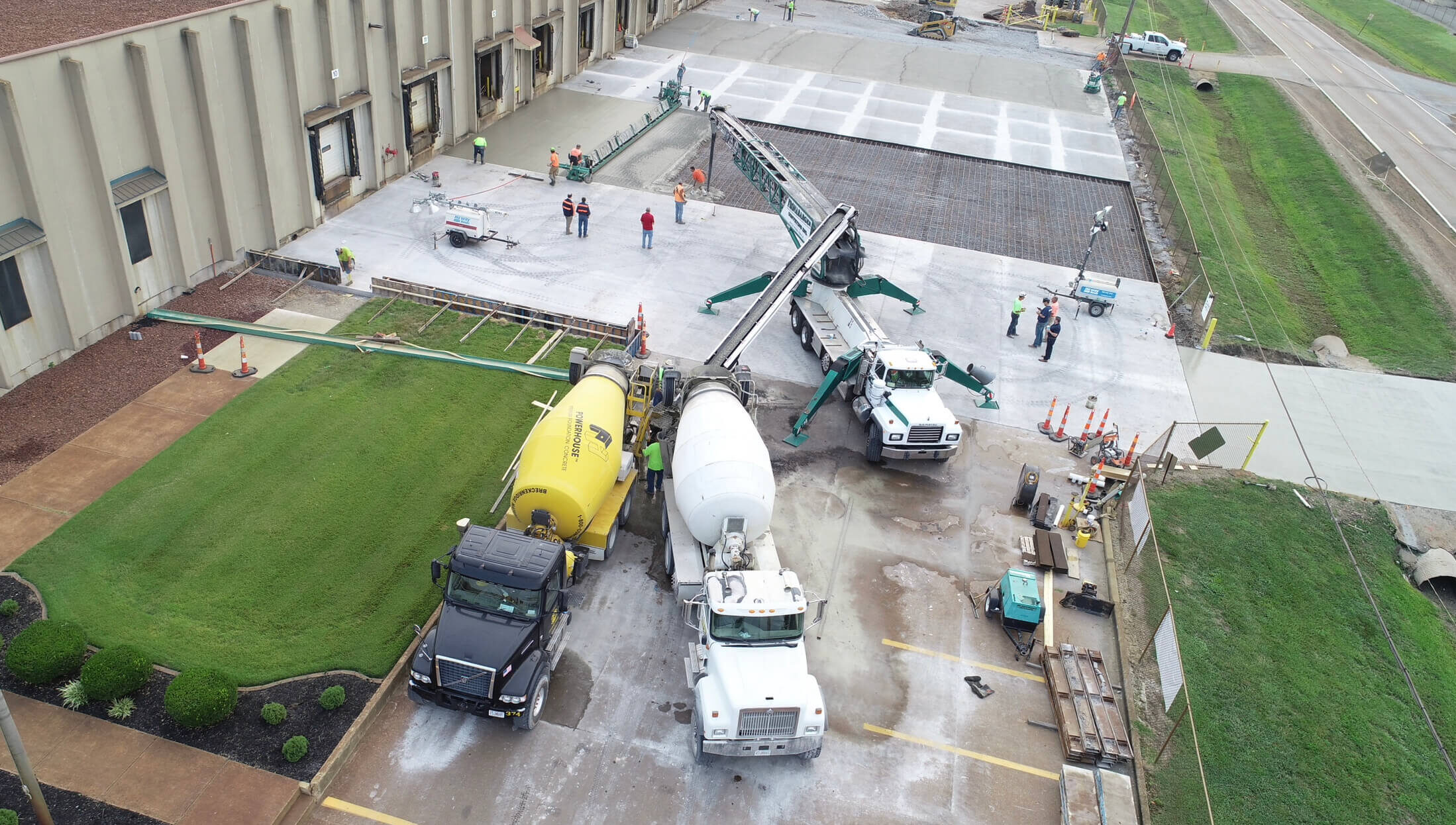 Two trucks pouring cement in Verdesian.